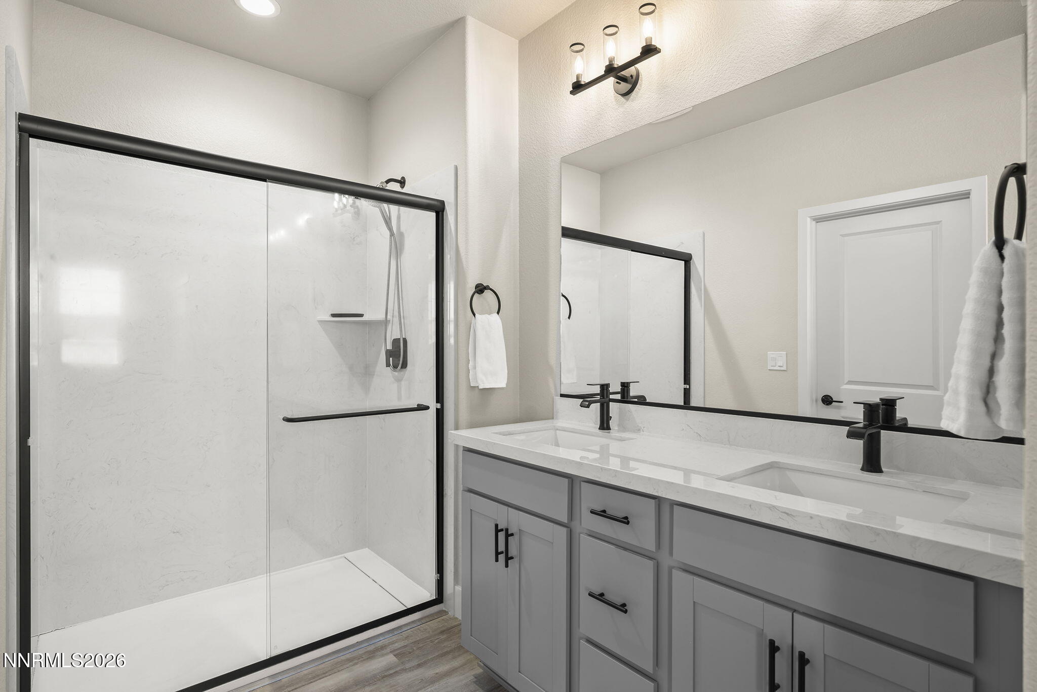 300 Cattail Circle Gardnerville, NV 89410 - Photo 13 of 39 a bathroom with a double vanity sink mirror and shower