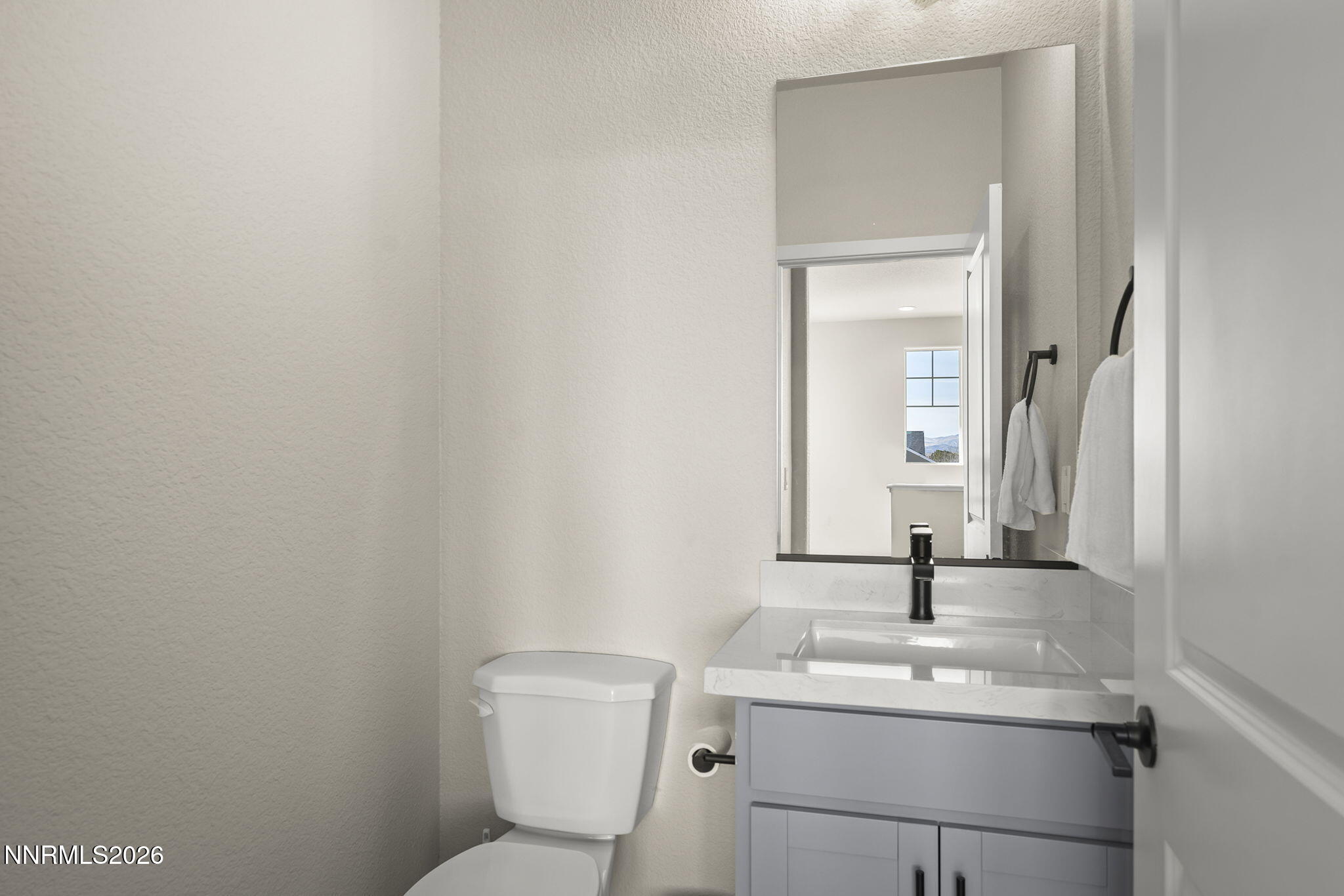 300 Cattail Circle Gardnerville, NV 89410 - Photo 14 of 39 a bathroom with a toilet sink and mirror