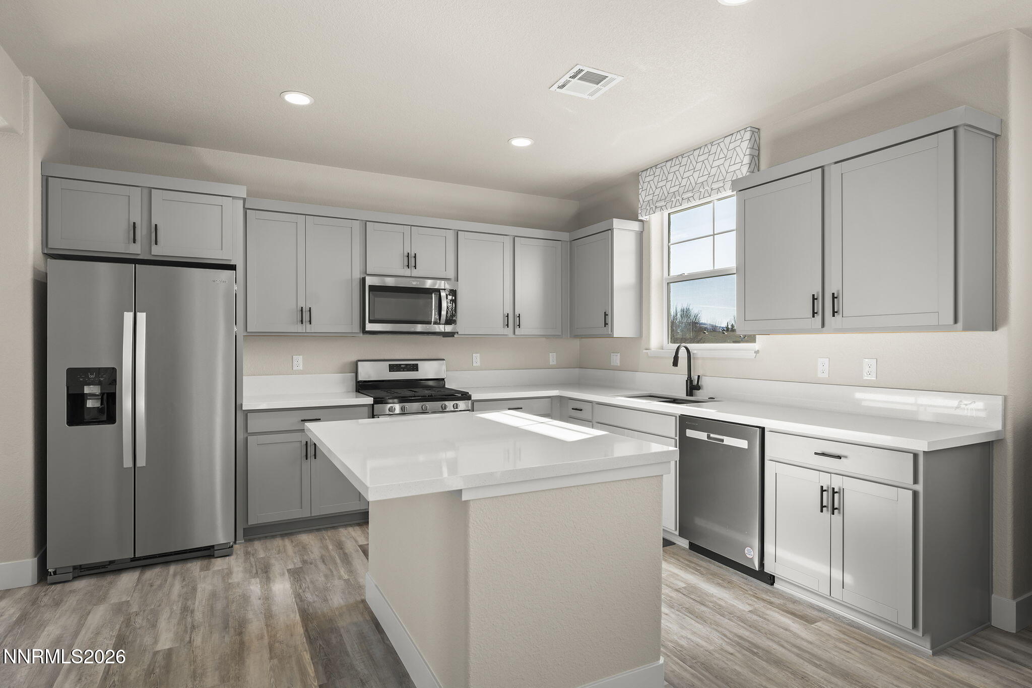 300 Cattail Circle Gardnerville, NV 89410 - Photo 7 of 39 a kitchen with a sink a refrigerator a microwave and cabinets