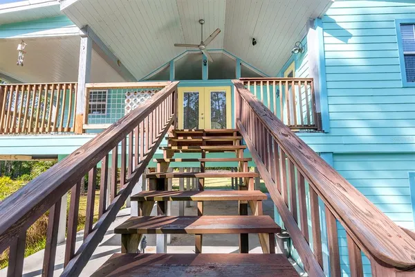 a view of staircase with lots of frames on wall and a large window