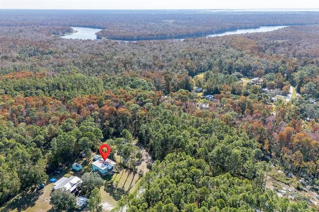an aerial view of a house with a yard