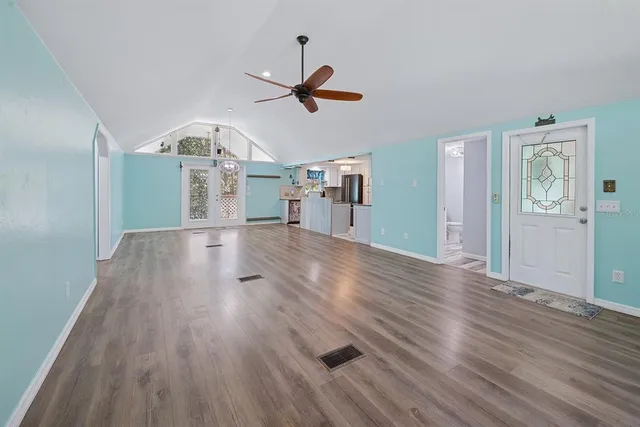a view of a kitchen with a sink cabinets and wooden floor