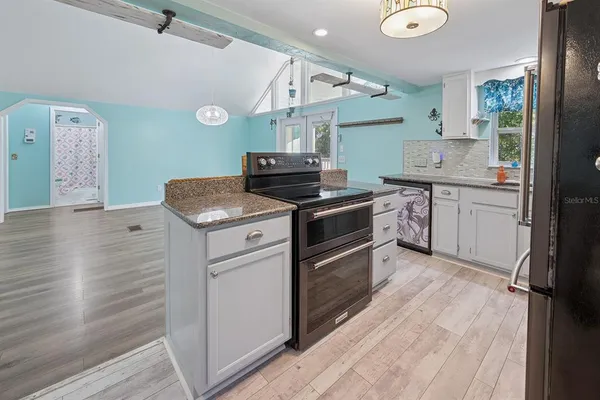 a kitchen with a sink stove and refrigerator