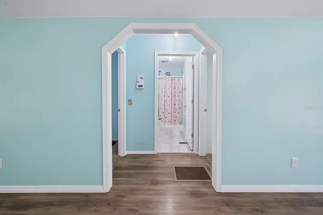 a bathroom with a granite countertop sink a mirror a shower and a sink