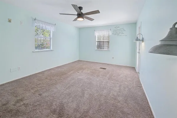 a view of empty room with a ceiling fan