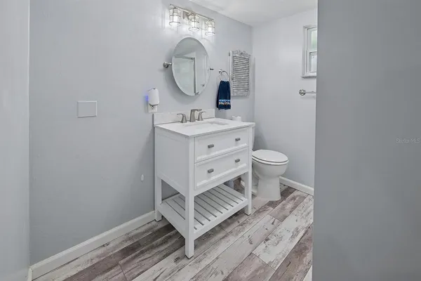 a bedroom with a bed and a mirror