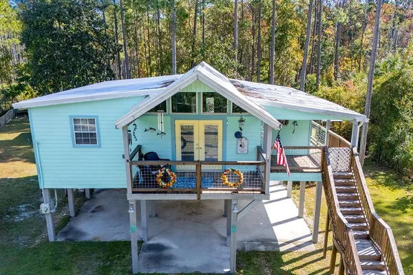an aerial view of a house with swimming pool and furniture