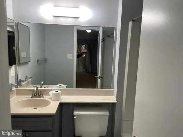 a view of a bathroom with a sink and a mirror
