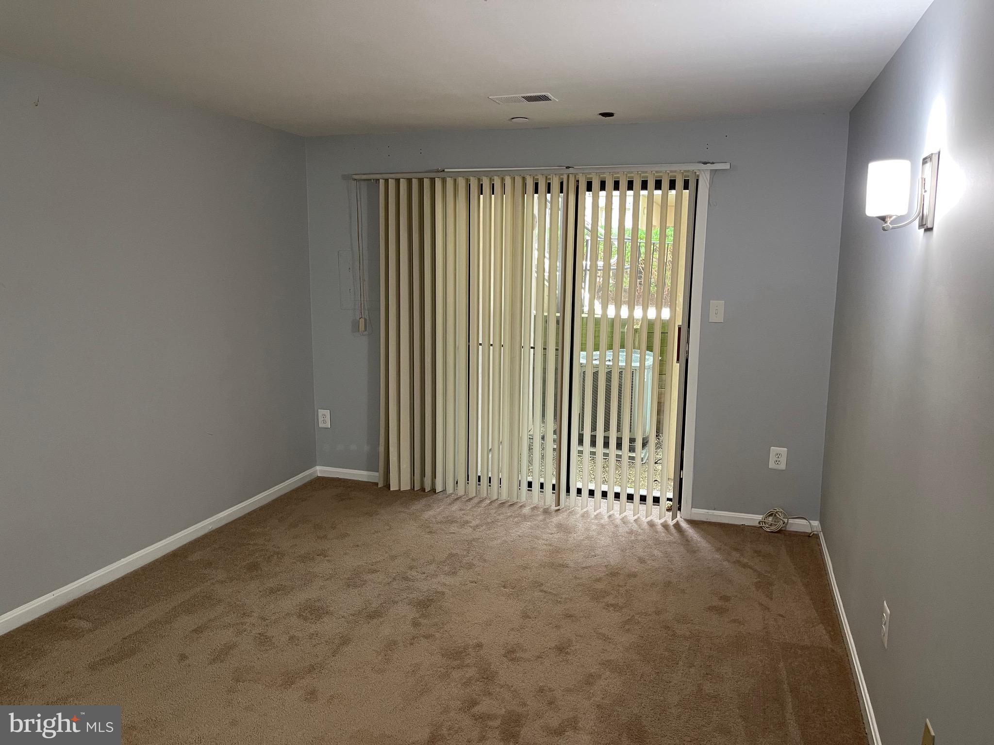 9815 Hellingly Place, Unit 75 Montgomery Village, MD 20886 - Photo 14 of 14 a view of an empty room with a window