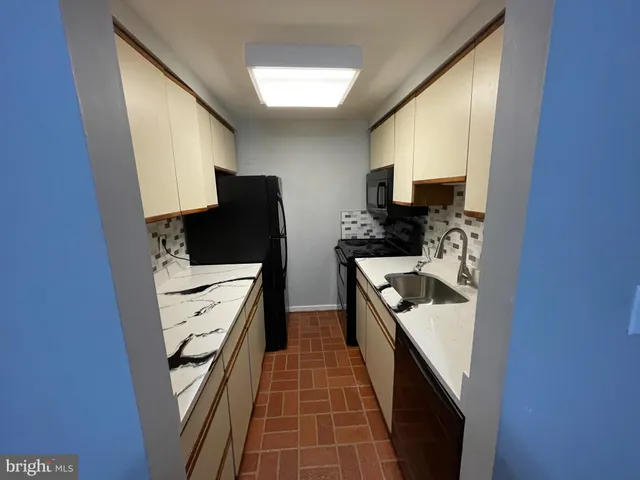 a kitchen with stainless steel appliances a refrigerator and a stove top oven
