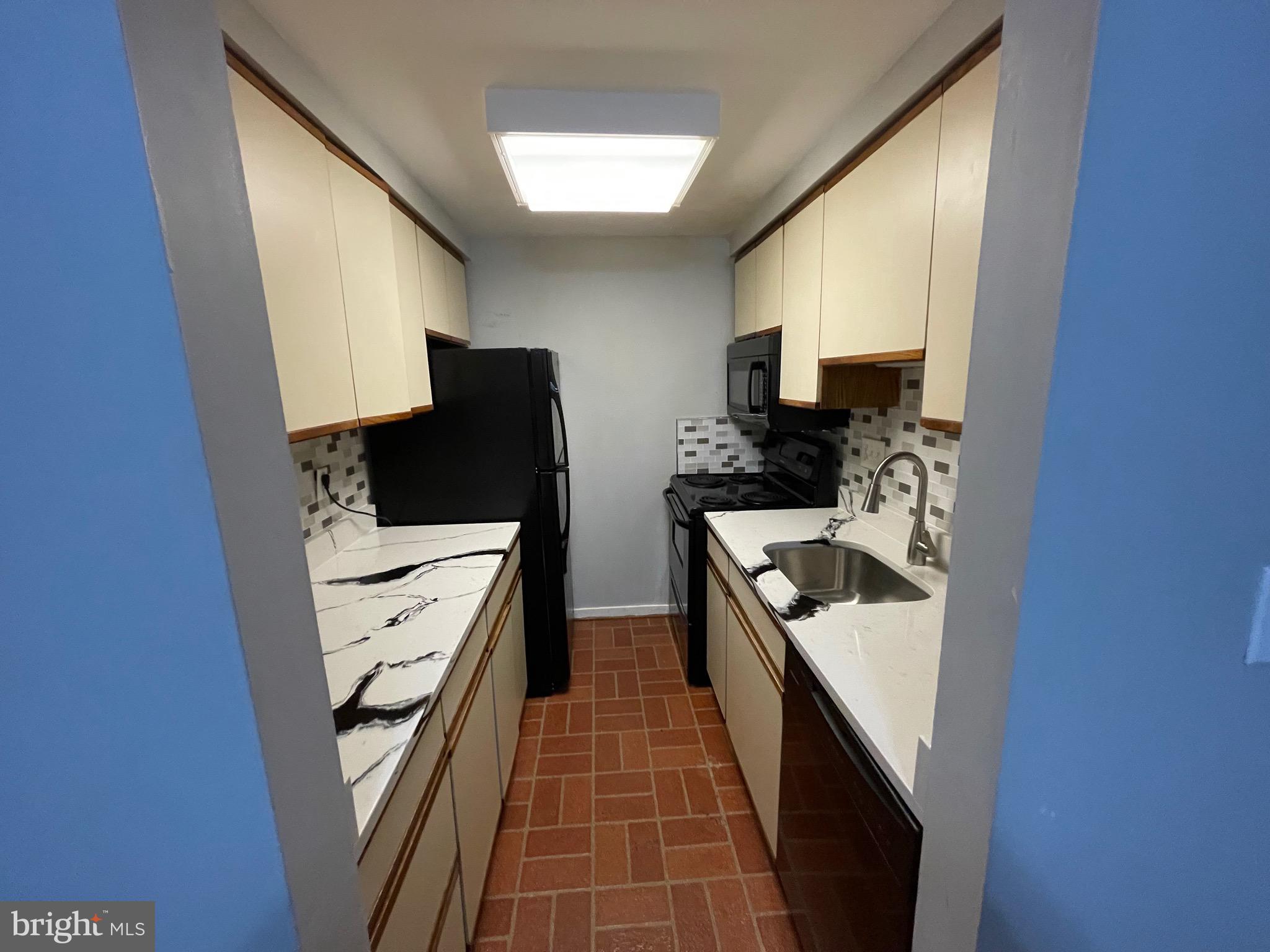 9815 Hellingly Place, Unit 75 Montgomery Village, MD 20886 - Photo 4 of 14 a kitchen with stainless steel appliances a refrigerator and a stove top oven