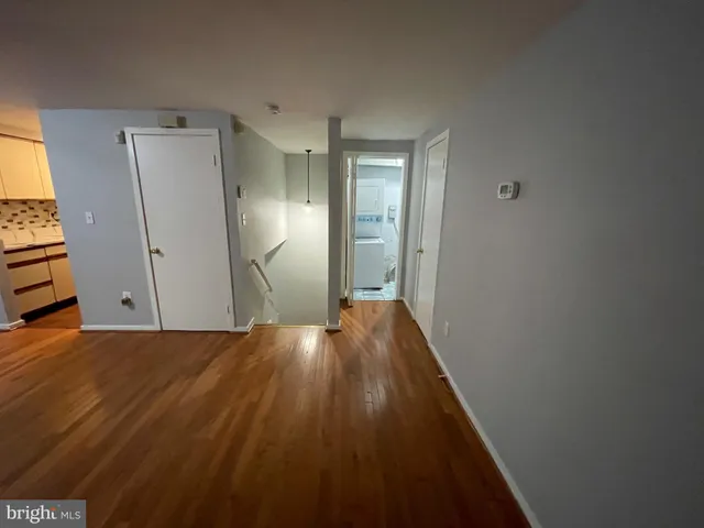 a view of hallway with wooden floor