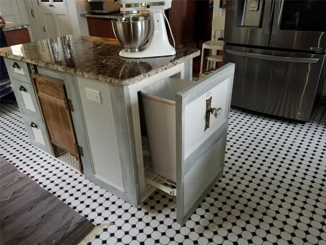 a kitchen with granite countertop a stove and cabinets