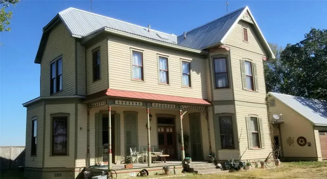 a view of a white house with large windows