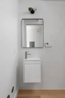 a bathroom with a sink a mirror and vanity