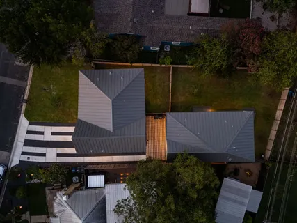 an aerial view of house with yard swimming pool and outdoor seating