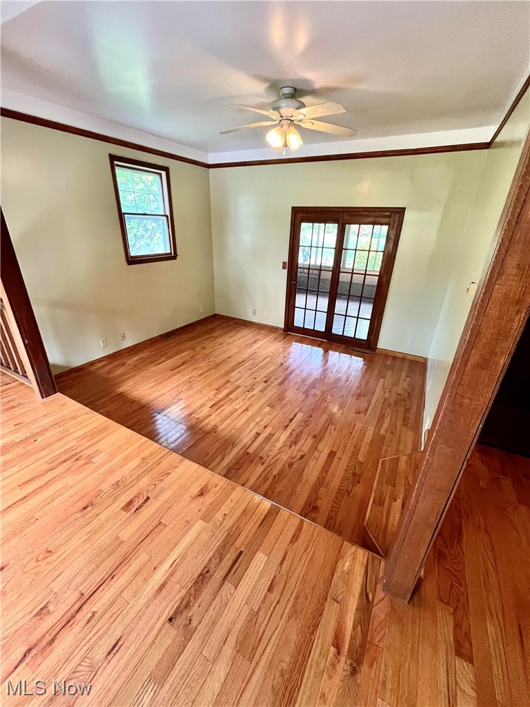 6543 North Ridge Road East Geneva, OH 44041 - Photo 21 of 49 Spare room with ornamental molding, ceiling fan, and light hardwood / wood-style flooring