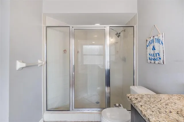 a bathroom with a shower and a toilet