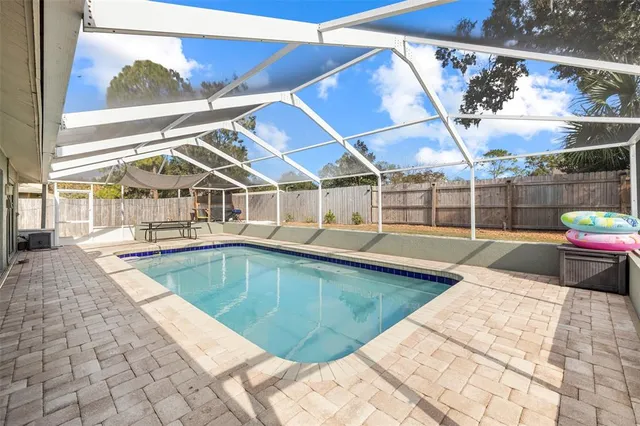 a view of a swimming pool with an outdoor seating