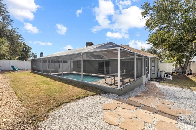 a view of a house with a yard and sitting area
