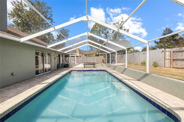 a view of a backyard with a swimming pool