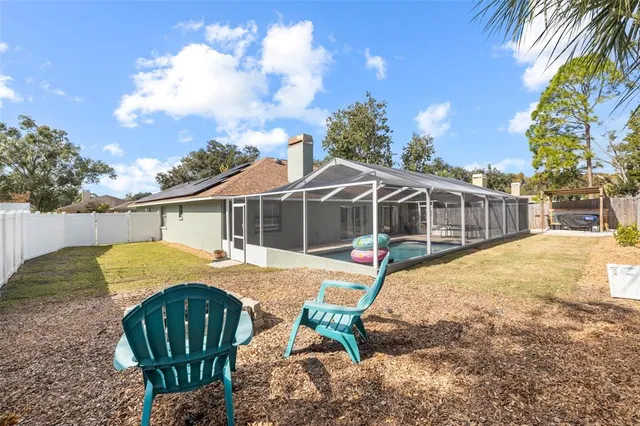 a view of a house with backyard and sitting area