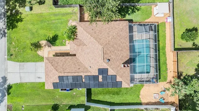 an aerial view of residential house with outdoor space and trees