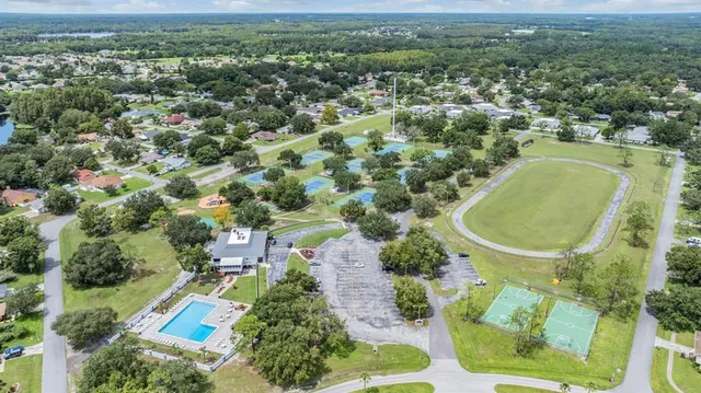an aerial view of residential houses with outdoor space and street view