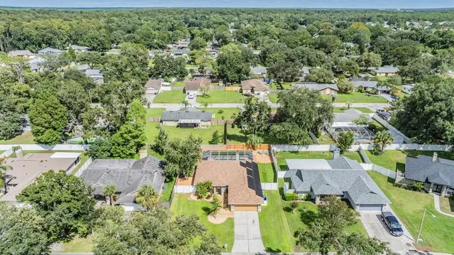 an aerial view of a house with yard swimming pool and outdoor seating
