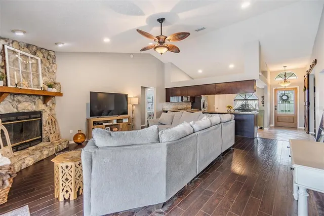 a living room with furniture a flat screen tv and a fireplace