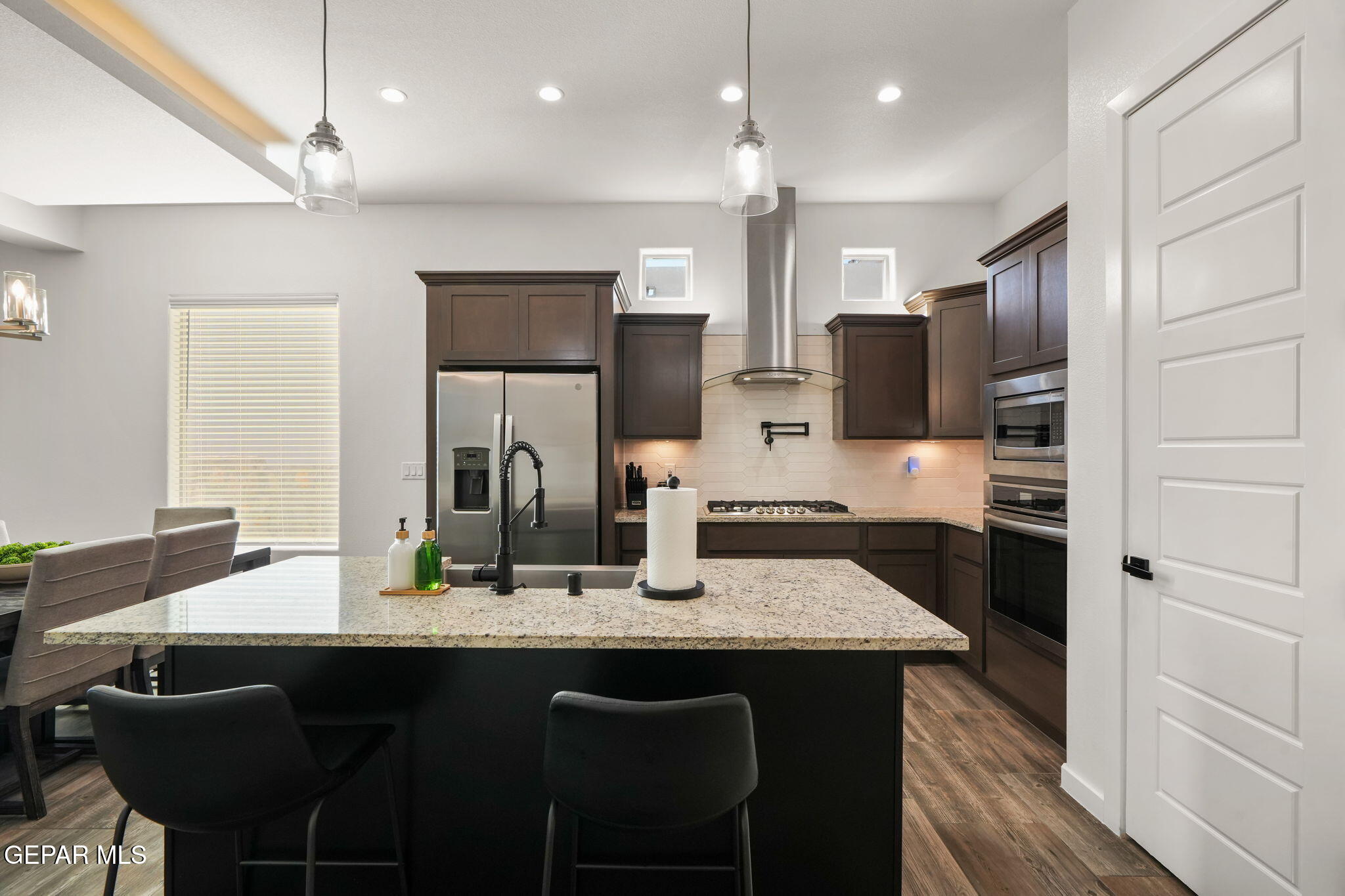 13070 Beccles Street El Paso, TX 79928 - Photo 12 of 43 a kitchen with stainless steel appliances granite countertop a sink refrigerator and cabinets