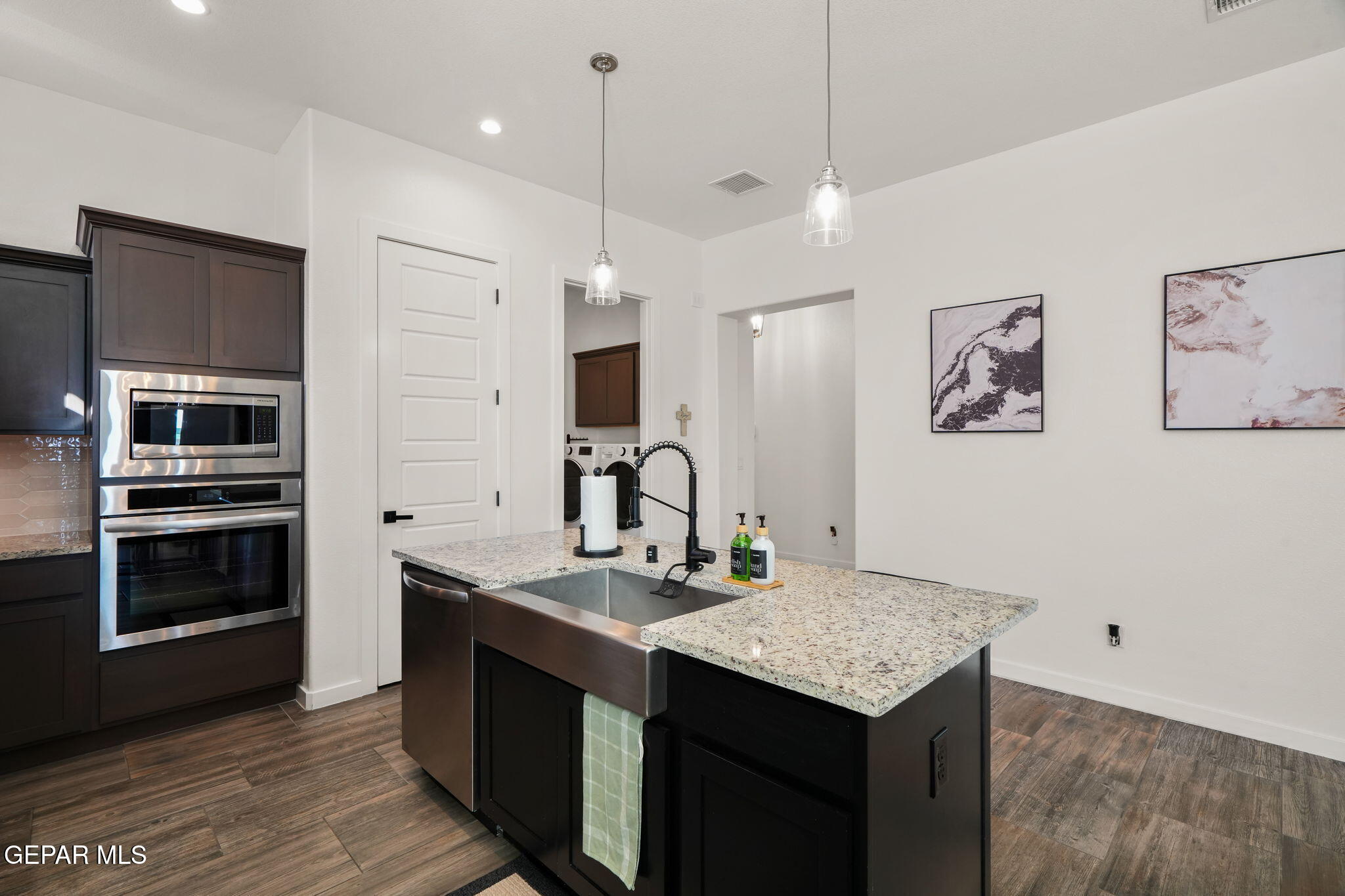 13070 Beccles Street El Paso, TX 79928 - Photo 15 of 43 a kitchen with stainless steel appliances granite countertop a kitchen island a stove and a sink