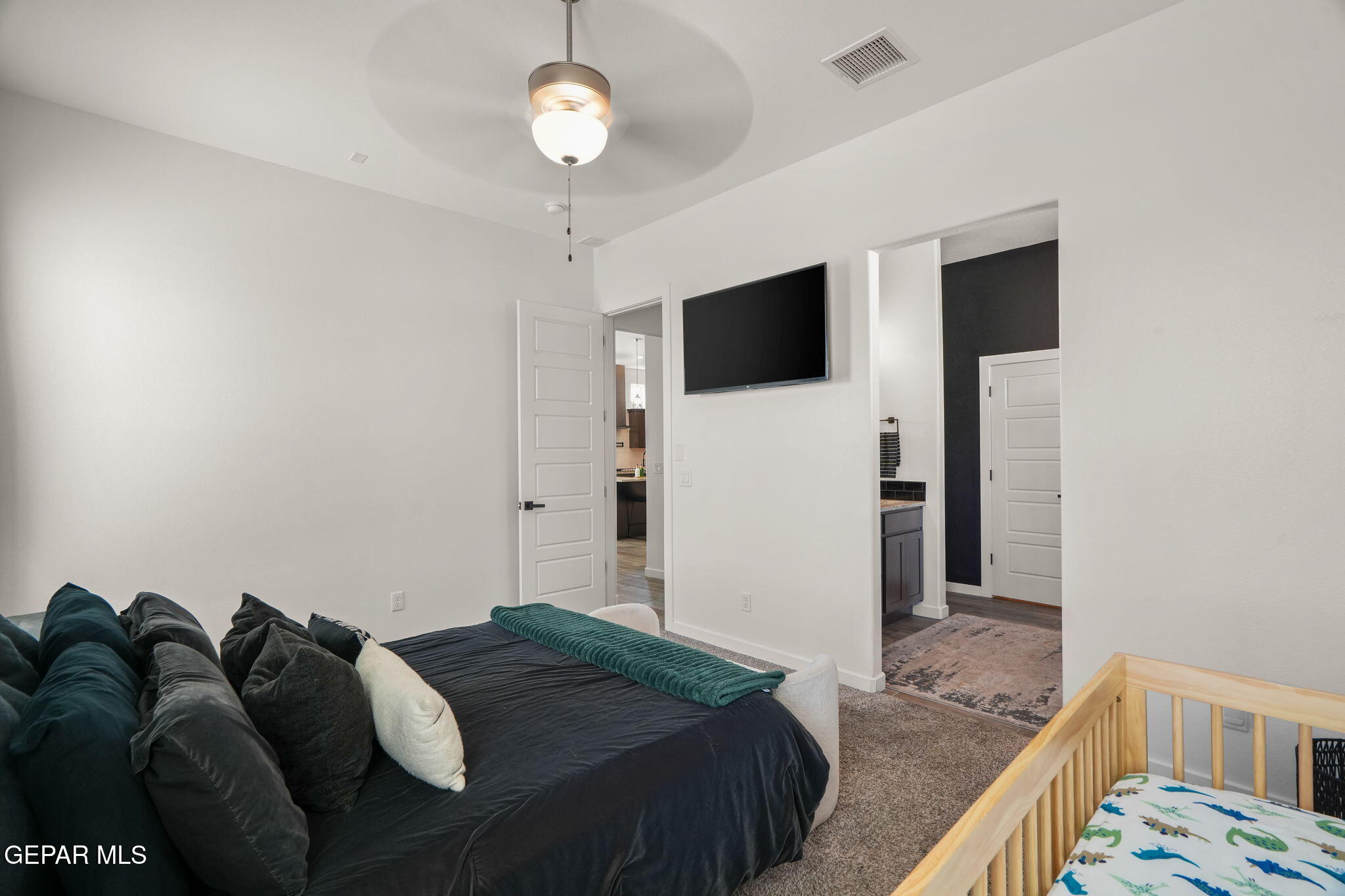 13070 Beccles Street El Paso, TX 79928 - Photo 25 of 43 a bedroom with a bed and a flat screen tv