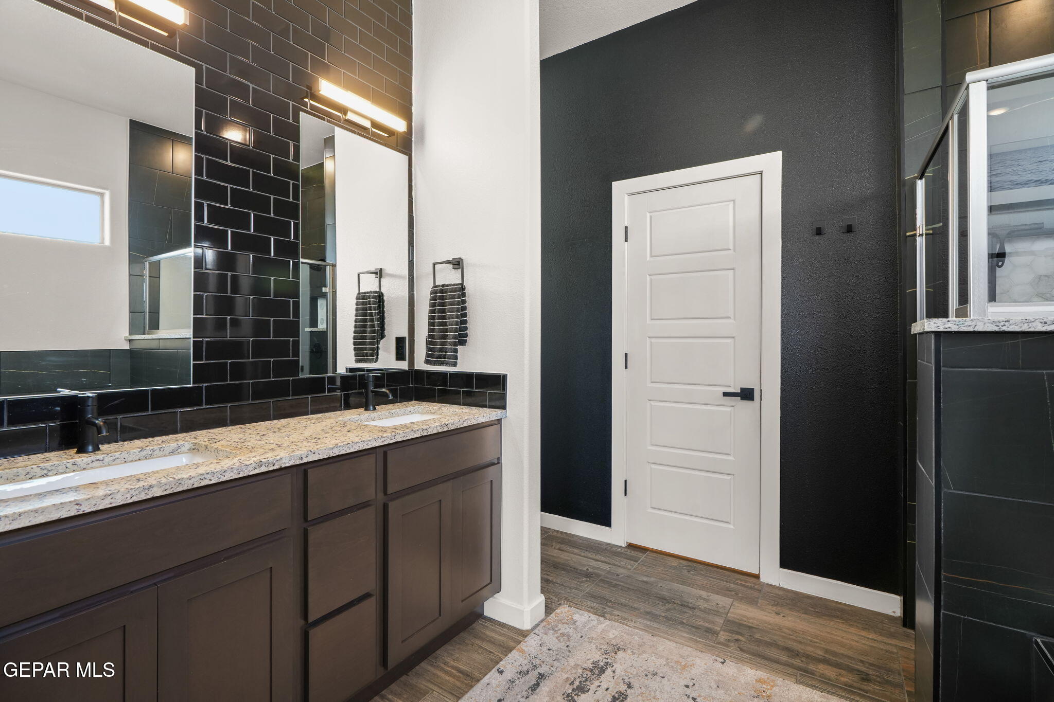 13070 Beccles Street El Paso, TX 79928 - Photo 27 of 43 a bathroom with a double vanity sink and mirror