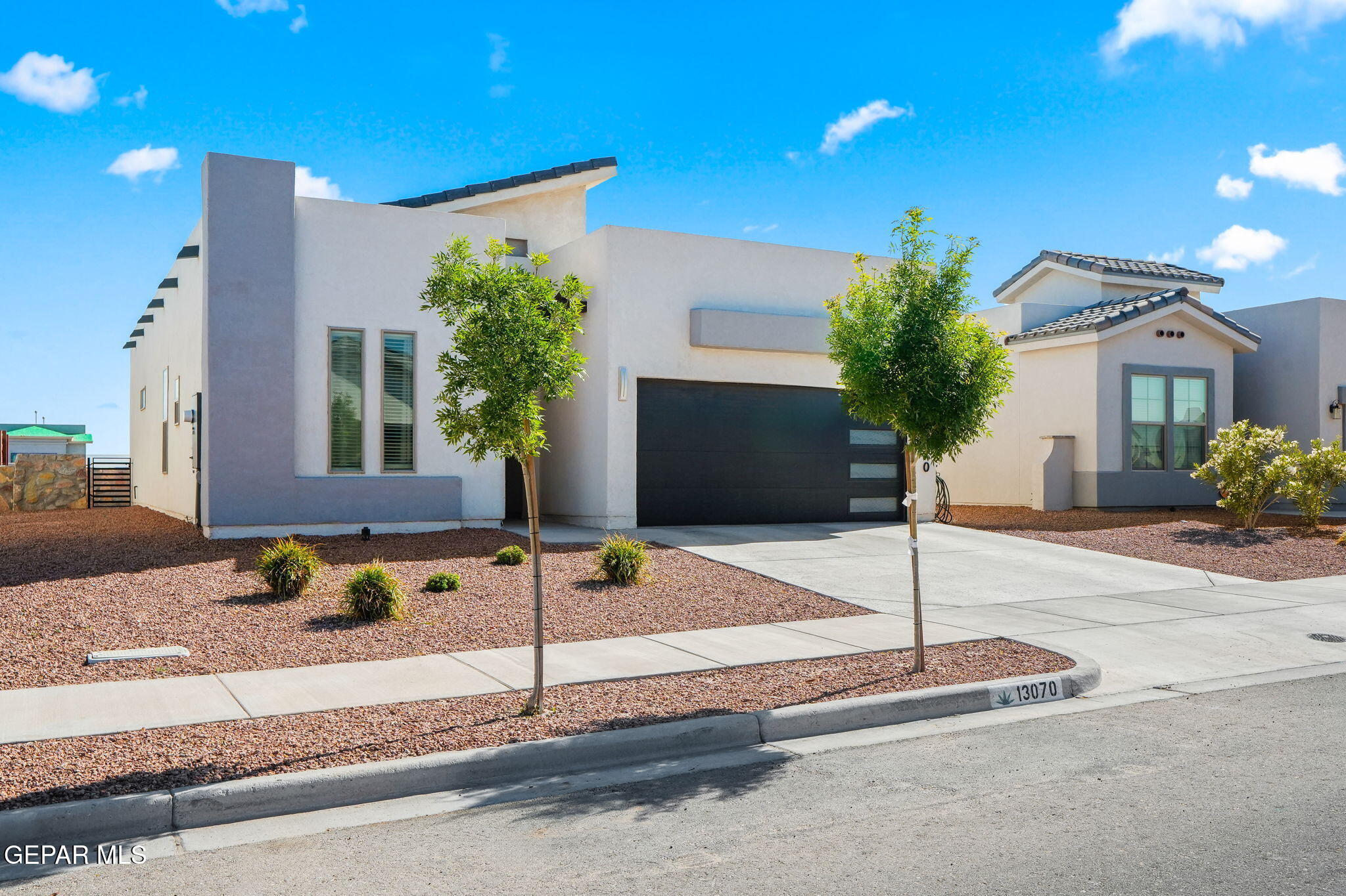 13070 Beccles Street El Paso, TX 79928 - Photo 3 of 43 a front view of a house with street