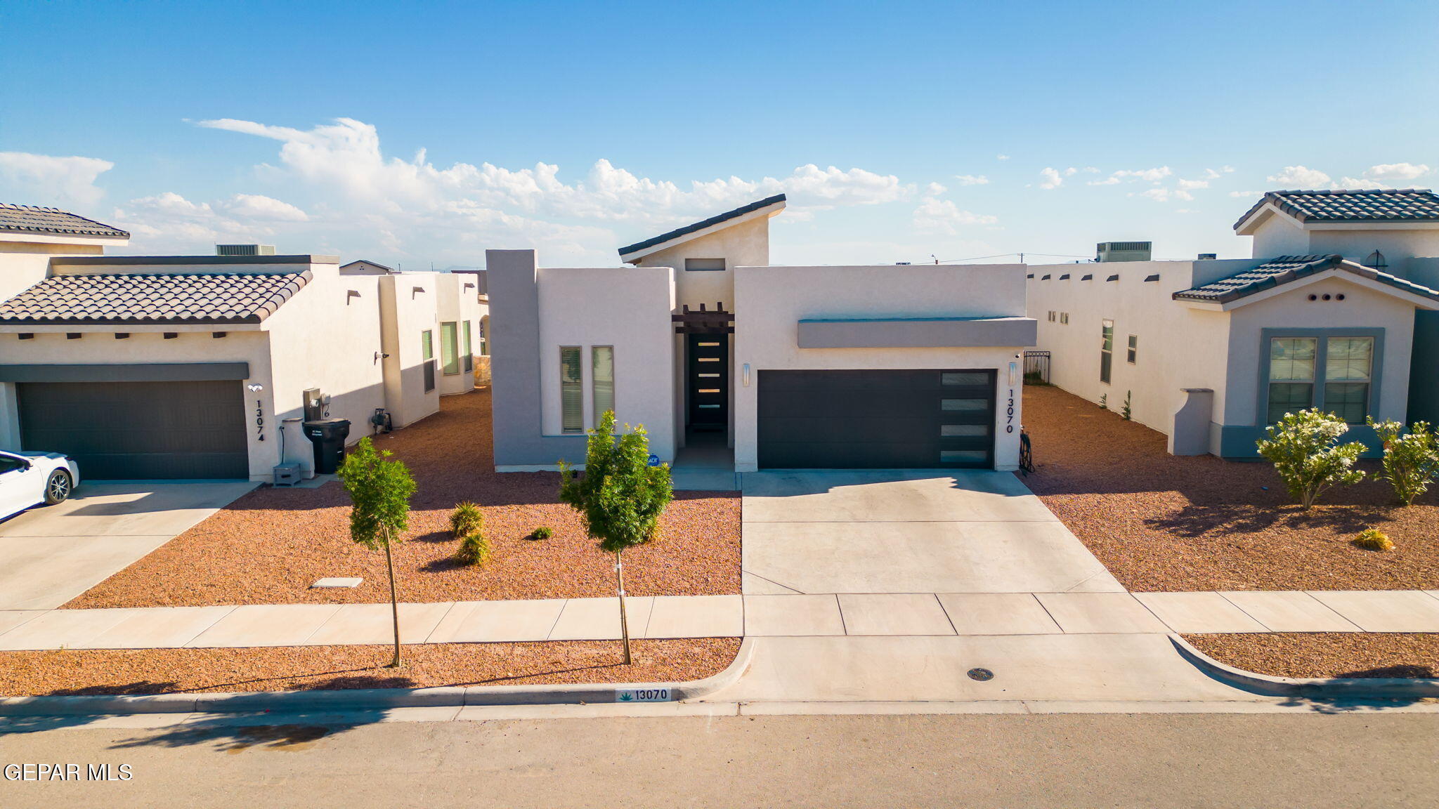 13070 Beccles Street El Paso, TX 79928 - Photo 36 of 43 a building with potted plants in front of it