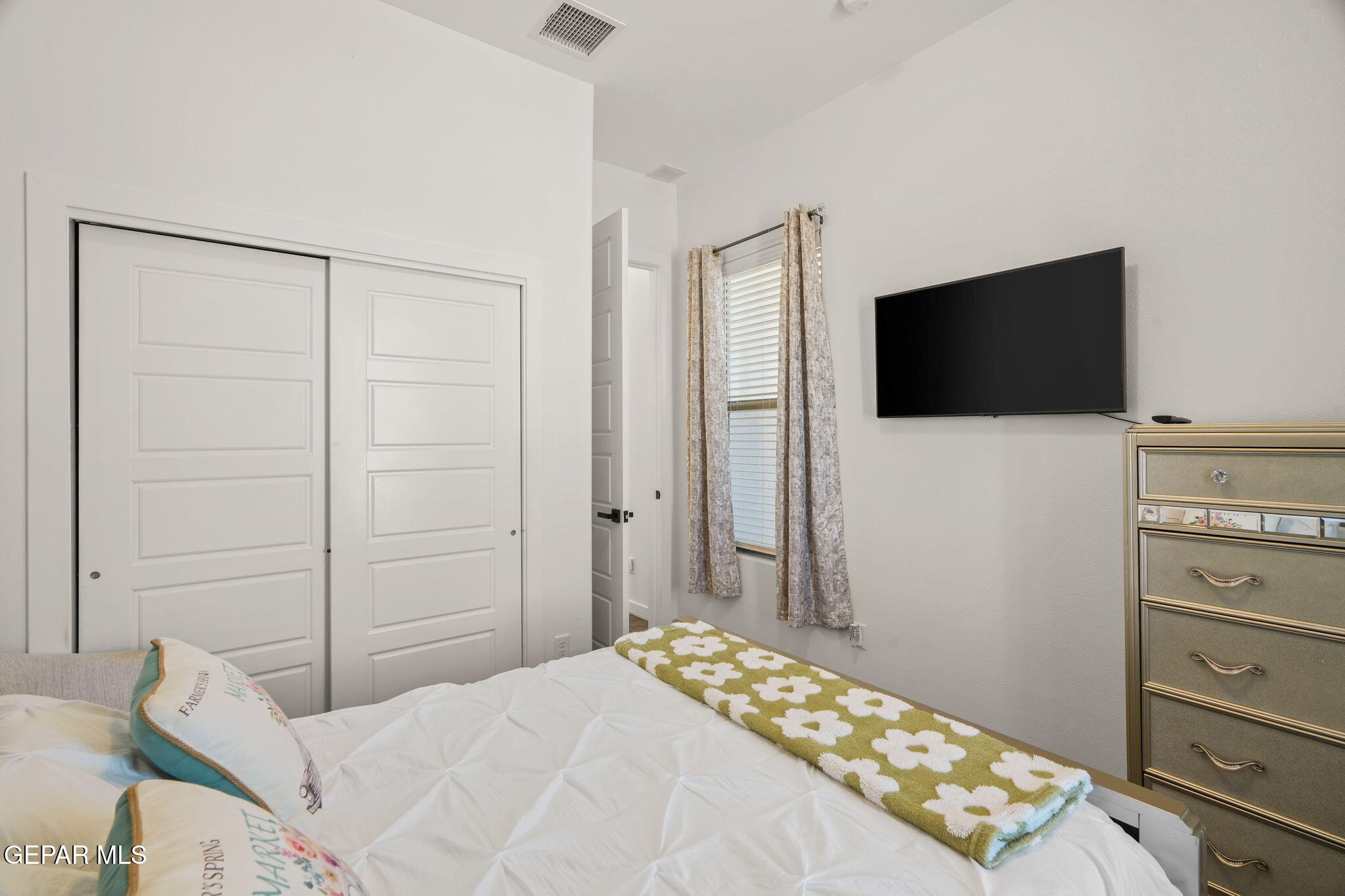 13070 Beccles Street El Paso, TX 79928 - Photo 6 of 43 a bedroom with a bed and a flat screen tv