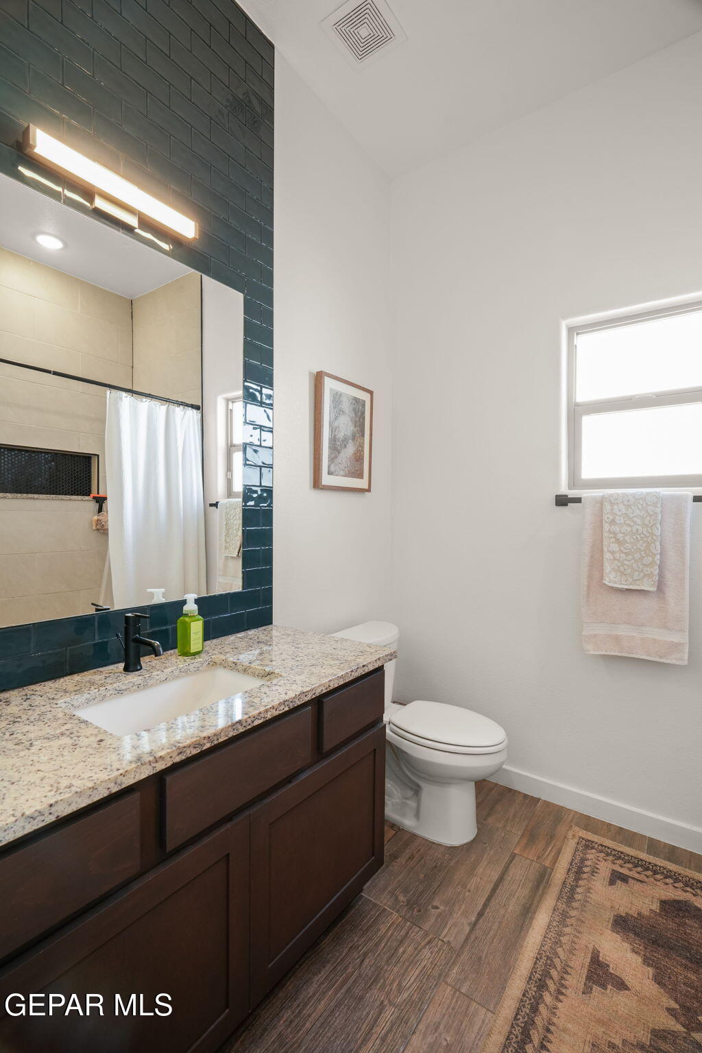 13070 Beccles Street El Paso, TX 79928 - Photo 7 of 43 a bathroom with a granite countertop toilet sink and mirror