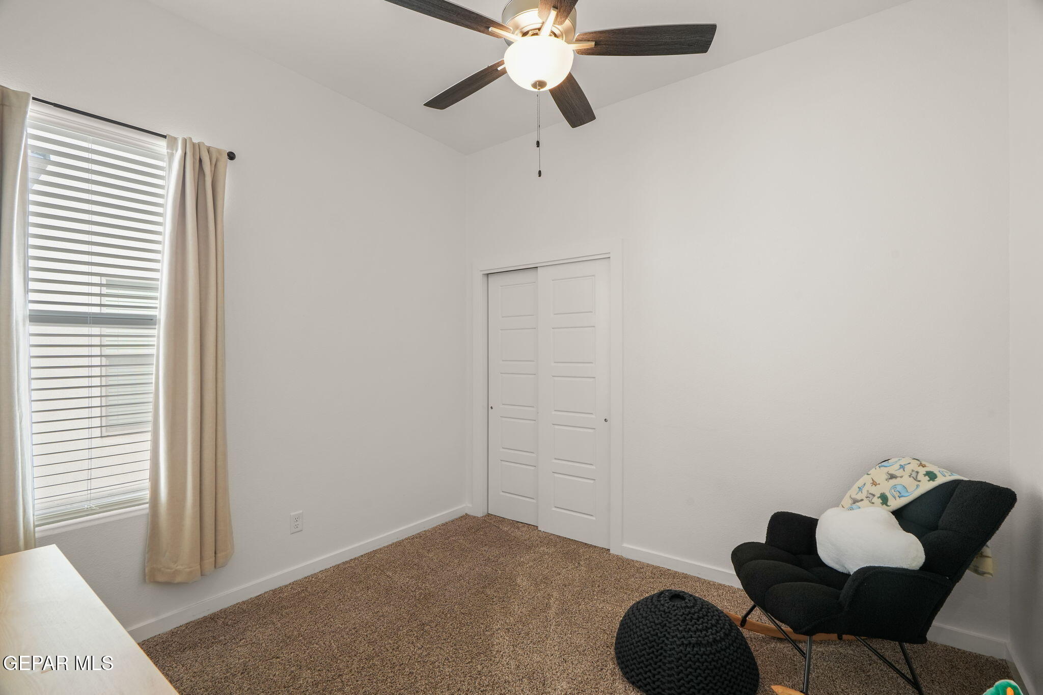13070 Beccles Street El Paso, TX 79928 - Photo 9 of 43 a bedroom with a bed and a chandelier fan