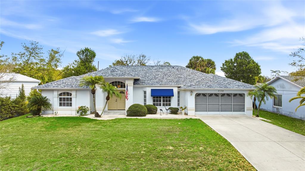 2134 Tinker Street Port Charlotte, FL 33948 - Photo 1 of 1 a front view of a house with garden