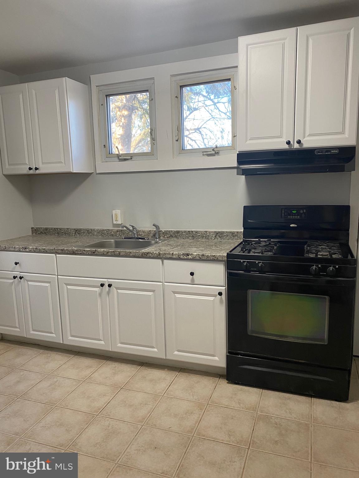640 Manor Road Beverly, NJ 08010 - Photo 6 of 22 a kitchen with granite countertop white cabinets and appliances