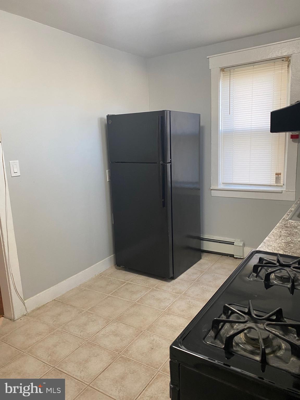 640 Manor Road Beverly, NJ 08010 - Photo 7 of 22 a kitchen with a stove and a refrigerator