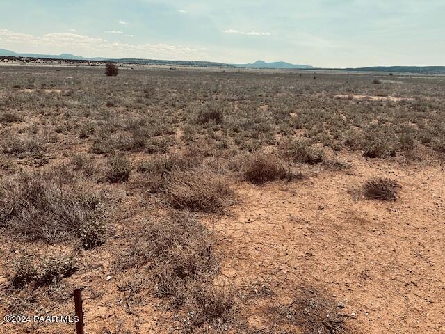 28551 West Hondo Road Seligman, AZ 86337 - Photo 3 of 5 a view of a dry field with wooden fence