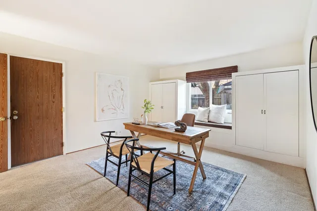 a view of a workspace room with furniture and wooden floor
