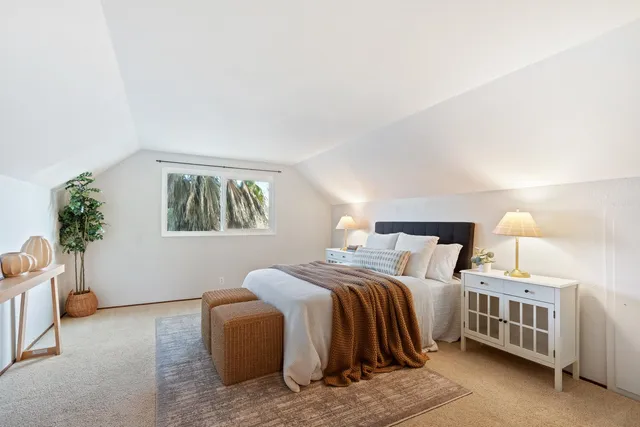 a bedroom with a bed and a couch