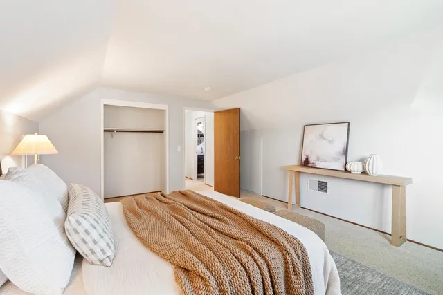 a bedroom with a bed and a potted plant