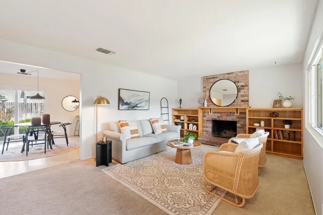 a living room with furniture a rug and a fireplace