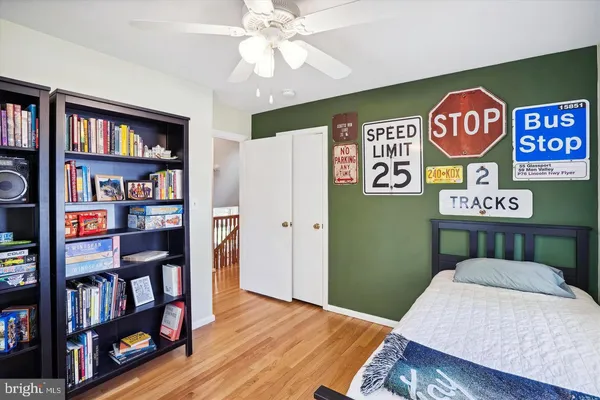 a view of a room with bookshelf and a book shelf