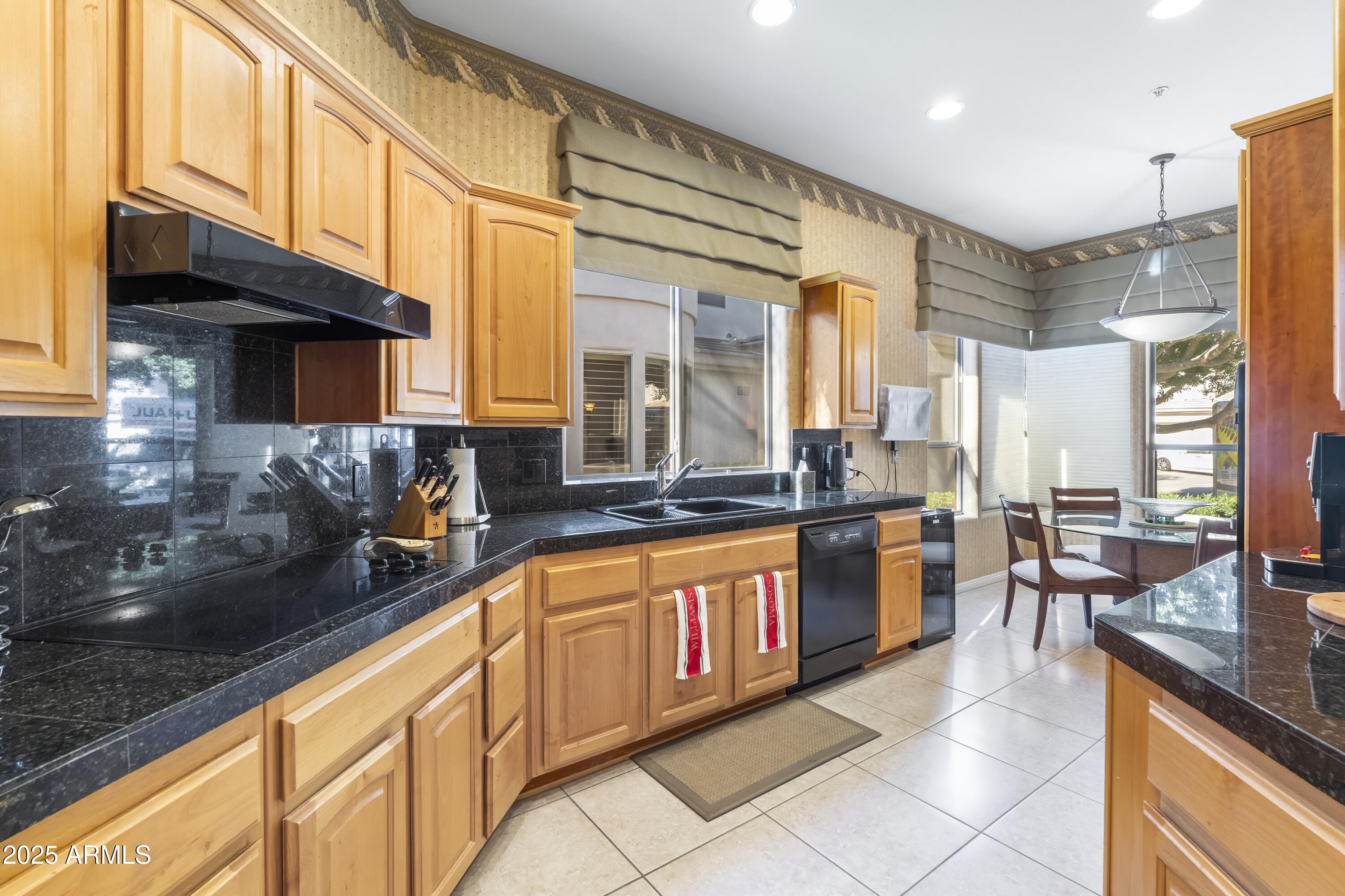 7267 East Vaquero Drive Scottsdale, AZ 85253 - Photo 13 of 37 a large kitchen with stainless steel appliances granite countertop a sink and cabinets