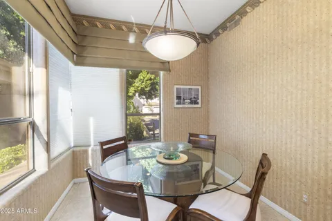 a dining room with furniture and window